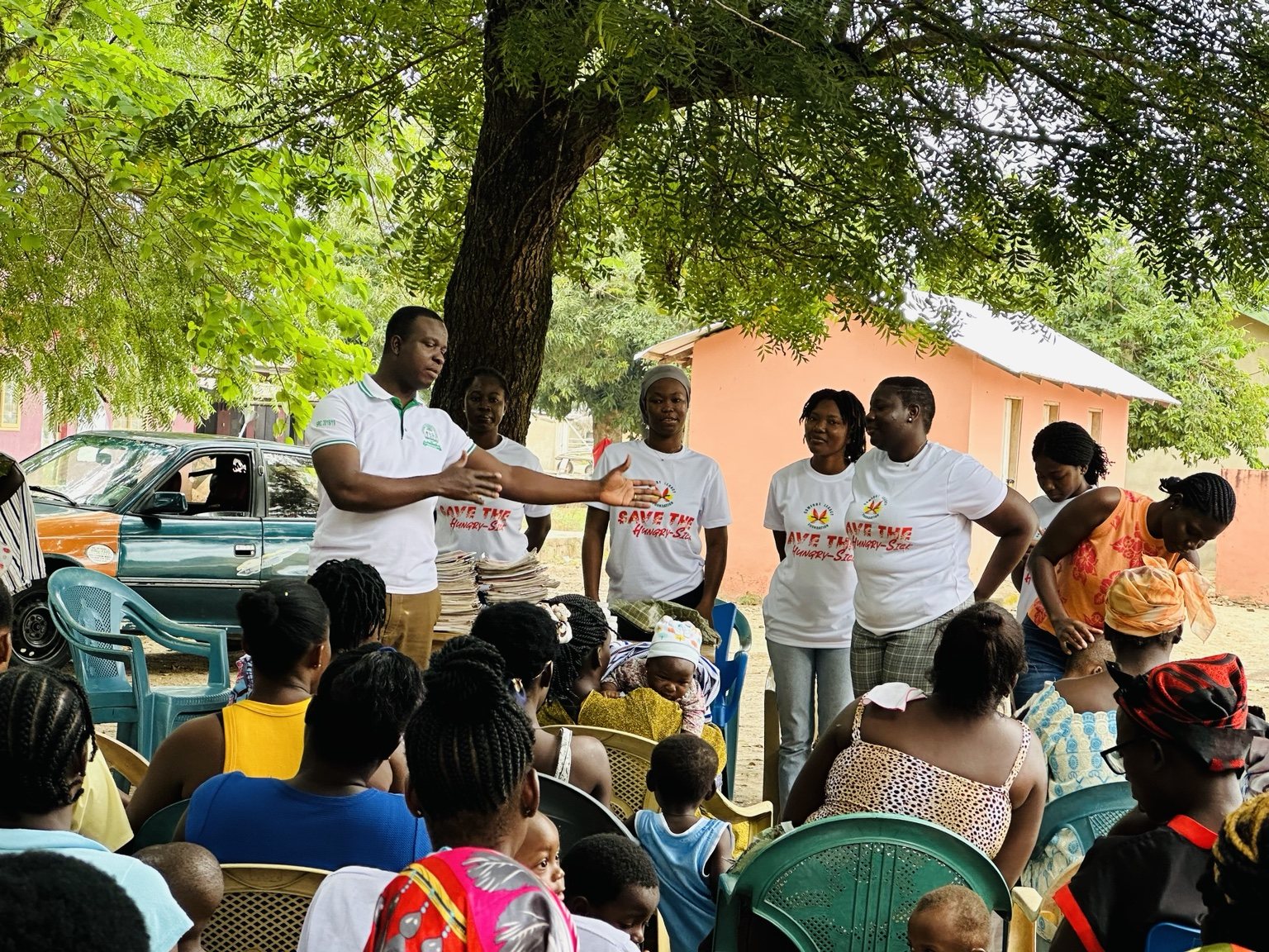 Comfort Legacy Foundation team addressing community participants during an outdoor outreach session